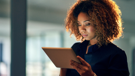 Woman looking at a tablet.