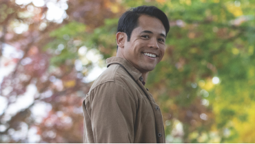 Smiling man with blurred trees in the background